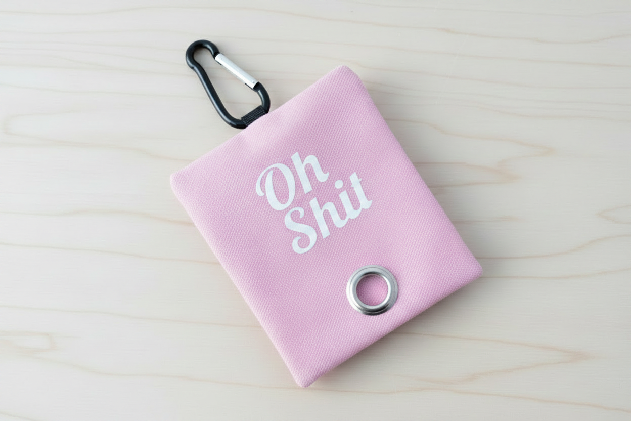 Oh Shit Poop Bag Holder in Pink on light wood background